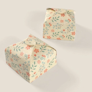 Macro detail of paper gift boxes featuring floral patterns and a vintage foldable design
