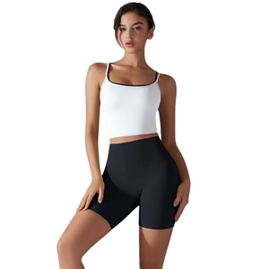 Women's white athletic crop top and high-waisted black yoga shorts workout set
