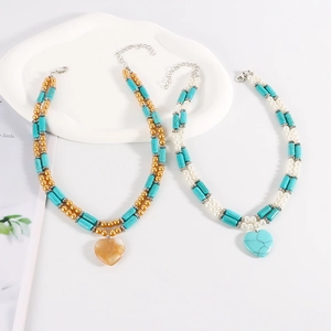 Detail of bohemian turquoise beaded necklaces with heart pendants and lobster clasps
