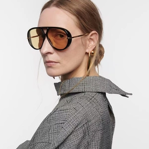 Side view of oversized cat-eye sunglasses with amber lenses and gold metal temples