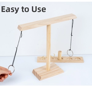 Detail of wooden ring toss game featuring the pine wood stand and metal hook mechanism