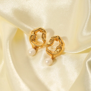 Vintage 18K gold plated lava earrings with freshwater pearls on beige silk fabric