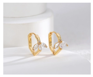 Detail of gold-plated leaf earrings with zircon crystals and S925 engraved stamp