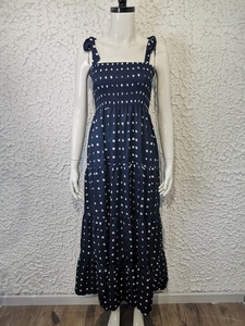 Detail view of navy floral maxi dress showing tie straps and tiered ruffle skirt layers