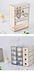 Detailed view of clear acrylic jewelry stand and drawer organizer on a desk