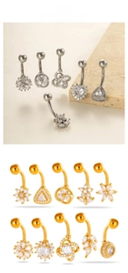 Detailed view of stainless steel belly rings with sparkling zircon and geometric designs