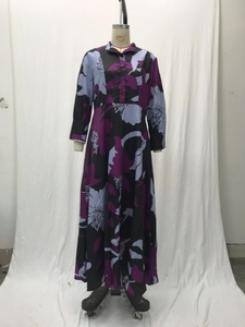 Detail of the high collar and buttoned placket on the floral print maxi dress