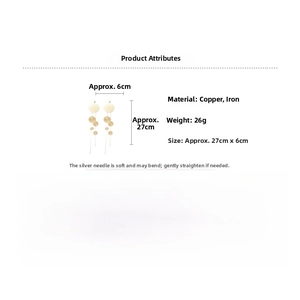 Detail view of long gold tassel earrings with size dimensions and silver needle specs