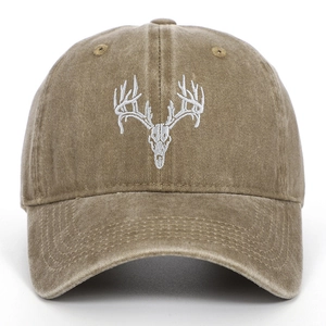 Detail of vintage washed cotton baseball cap featuring white elk skull embroidery