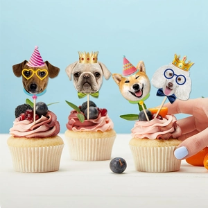 Detail view of dog-themed cupcake toppers featuring pugs and shiba inu with party hats