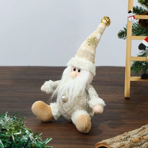 Close-up of knitted Christmas gnomes with faux fur on a rustic wooden table setup