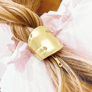 Elegant gold alloy pony hook hair clip with curved minimalist design on brown hair