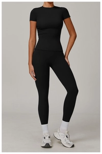 Close-up of black high-waisted yoga set featuring short sleeve top and leggings