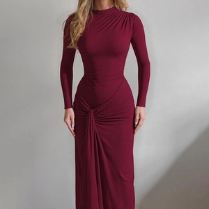 Detailed view of the elegant ruching and draped fabric texture on this wine red maxi dress