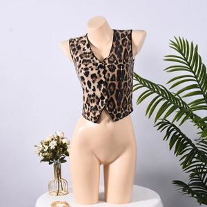 Detail of leopard print sequin vest with V-neckline and buttons on a female mannequin