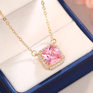Macro shot of pink square crystal necklace in a luxury blue velvet jewelry gift box