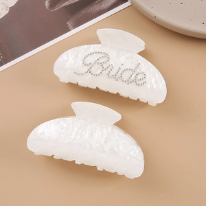 Detail of white marble acrylic hair claw clips with rhinestone Bride lettering set