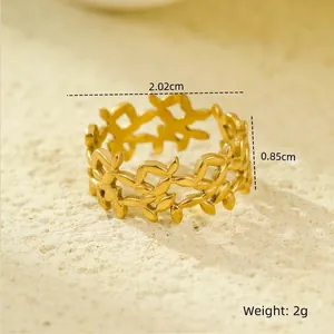 Detailed view of 18K gold leaf cutout ring on stone background with size dimensions