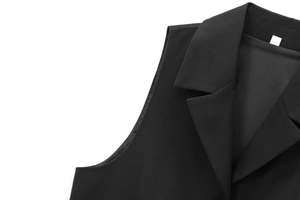 Detail of a black standing collar vest showing fabric texture and neat stitching