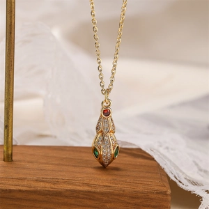 Macro shot of gold-plated dinosaur pendant with multicolor crystals on a wooden stand