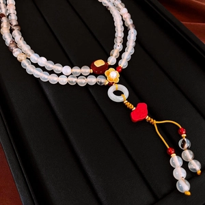 Detailed macro view of New Chinese style floral pearl necklace with carnelian beads