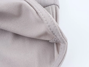 Close-up of premium knit fabric texture and sewing craftsmanship on elegant halter top