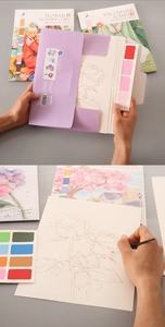 Detail view of watercolor coloring set featuring floral cards and a purple paper sleeve