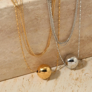 Layered stainless steel necklace with large gold and silver polished ball pendants