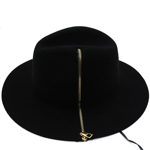 Detail of a black wool bucket hat featuring a stylish vertical gold metal zipper design