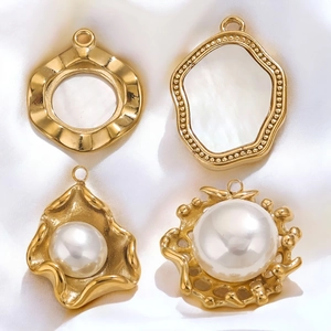 Detail of DIY jewelry charms in gold stainless steel with pearls and shell elements