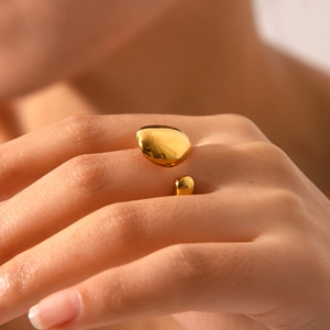 Macro view of adjustable 18K gold plated stainless steel ring with organic lava design