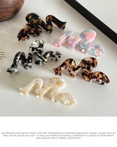Close-up of geometric acetate hair claws in tortoise shell and marble patterns