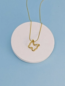 Detail of golden hollow butterfly pendant on a sleek snake chain over a blue background