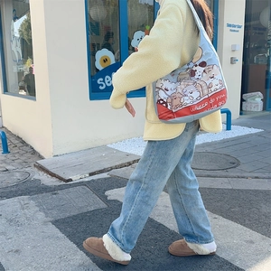 Outdoor shot showing a large light blue canvas tote bag with cartoon dog prints