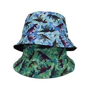 Detail of blue and green camo bucket hats with purple dinosaur silhouettes on canvas