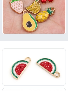 Close-up of mini alloy fruit charms including strawberry and watermelon for DIY jewelry