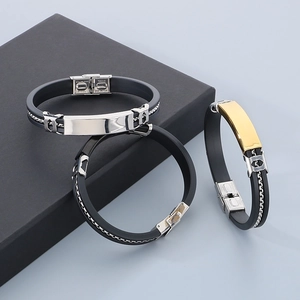 Close-up of silicone and stainless steel men's bracelets showing buckles and metal plates