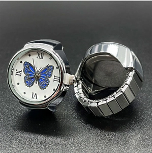 Detailed view of silver quartz ring watch with butterfly dial and elastic metal band