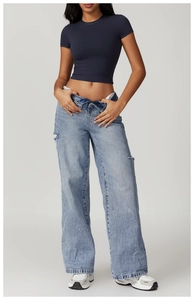 Detail of high-waist distressed jeans paired with a slim-fit navy crop top yoga shirt