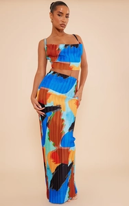 Close-up of plissé fabric texture and abstract print on women's two-piece set