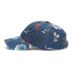 Detail view of denim baseball cap featuring vintage floral print and standard curved brim