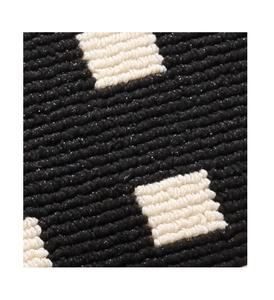 Close-up of thick tufted texture and geometric pattern on cream round carpet