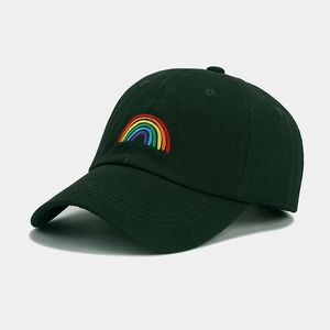 Close-up of rainbow embroidery detail on dark green cotton canvas baseball cap