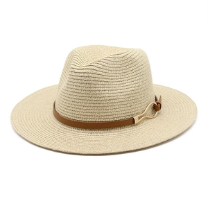 Classic beige Panama straw hat with brown leather band and gold buckle on white background