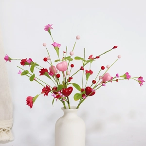 Artificial red carnations with heart picks in a white ceramic vase for Valentine decoration