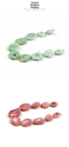 Macro detail of irregular natural druzy stone beads in pink and green colors