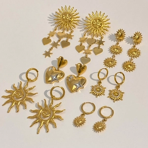 Set of gold stainless steel star and sun dangle earrings with elegant tassel details