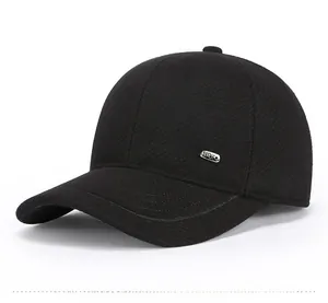 Detail of outdoor winter sports cap showing silver metal logo and premium twill fabric
