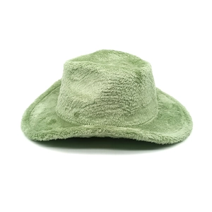 Detailed close-up of light green faux fur cowboy hat with soft plush texture and wide brim