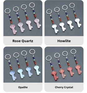 Detail view of heart-shaped crystal keychains with chakra beads in multiple stones